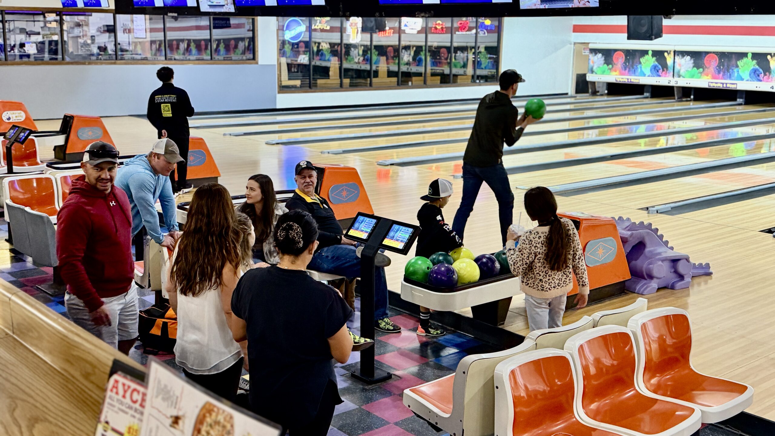 Groups of adults and kids bowling at Tenpins & More