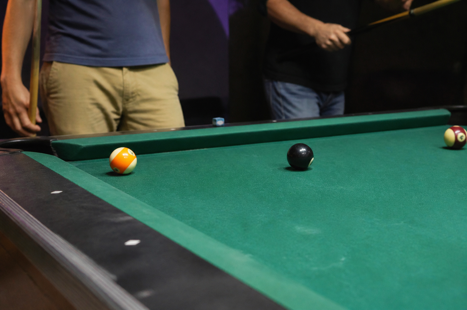 Guests playing billiards at Tenpins & More