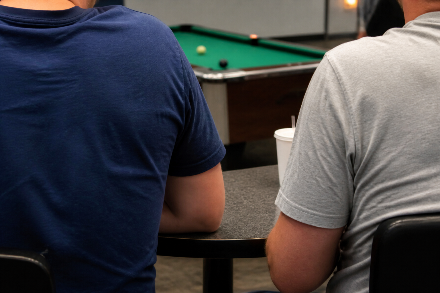 Guests relaxing near the billiards table at Tenpins & More