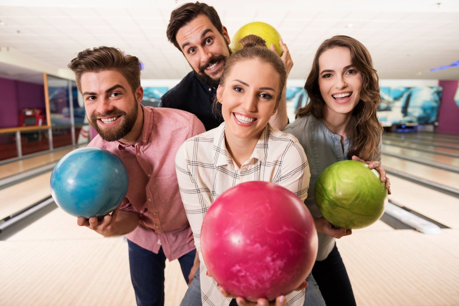 Friends laughing together at the bowling alley